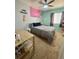 Bright bedroom with modern decor including a ceiling fan, a comfy bed, and an accessory shelf at 4614 Lyndenwood Cir, Highlands Ranch, CO 80130