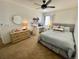 Bright bedroom includes a ceiling fan, a comfy bed, a desk, and a large window offering plenty of natural light at 4614 Lyndenwood Cir, Highlands Ranch, CO 80130