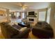 Inviting living room with fireplace, large sofas, and a view into the next room at 4614 Lyndenwood Cir, Highlands Ranch, CO 80130