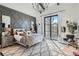 Bright bedroom featuring a modern chandelier, gray accent wall and a large window with natural light at 21429 Trappers Trl, Morrison, CO 80465