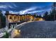 Gorgeous exterior view with stunning architecture and beautiful landscaping at twilight at 21429 Trappers Trl, Morrison, CO 80465