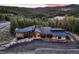 Beautiful home exterior with architectural design, dark roof, stone accents, and mountain views at 21429 Trappers Trl, Morrison, CO 80465