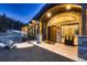 Elegant front entrance with stone details, arched window, and modern lighting at 21429 Trappers Trl, Morrison, CO 80465
