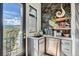 Charming kitchenette featuring modern appliances, stylish decor, and a door leading to outdoor enjoyment at 21429 Trappers Trl, Morrison, CO 80465