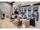 Inviting living room featuring modern decor, a cozy fireplace, and large windows with scenic views at 21429 Trappers Trl, Morrison, CO 80465