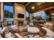 Relax on this beautiful outdoor living area with stone fireplace and mountain views at 21429 Trappers Trl, Morrison, CO 80465
