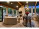 Relaxing outdoor patio with stone fireplace, comfortable seating, and scenic views of the surrounding woods at 21429 Trappers Trl, Morrison, CO 80465
