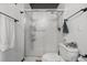 Clean, white bathroom features a glass-enclosed shower and a decorative octopus accent on the toilet at 1555 California St # 419, Denver, CO 80202