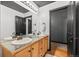 Bathroom with double sinks, dark trim and adjacent toilet room at 1555 California St # 419, Denver, CO 80202