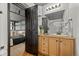 Modern bathroom featuring double sink vanity, granite countertop, and an open door to the bedroom at 1555 California St # 419, Denver, CO 80202