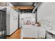 Bedroom view with hardwood floors, ductwork, desk and white iron bed at 1555 California St # 419, Denver, CO 80202