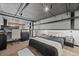 Bedroom features exposed ductwork, dark trim, a desk area and modern lighting at 1555 California St # 419, Denver, CO 80202