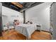 Cozy bedroom featuring exposed ductwork, hardwood floors and a comfortable sleeping space at 1555 California St # 419, Denver, CO 80202