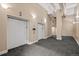 Hallway with two elevator doors, neutral paint, carpeted floors, and modern lighting fixtures at 1555 California St # 419, Denver, CO 80202
