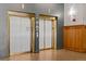 Two elevators with brass finishes and wood panels offer convenient access to building floors at 1555 California St # 419, Denver, CO 80202