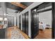 Hallway that opens to a bedroom with a bed, features dark doors and good lighting at 1555 California St # 419, Denver, CO 80202