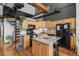Well-lit kitchen with wood cabinets, an island, and a spiral staircase, exuding a cozy and inviting atmosphere at 1555 California St # 419, Denver, CO 80202
