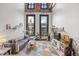 Bright living room with large windows, exposed brick, modern furniture, and a decorative geometric rug at 1555 California St # 419, Denver, CO 80202