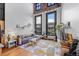 Bright living room with large windows, exposed brick, modern furniture, and a decorative geometric rug at 1555 California St # 419, Denver, CO 80202