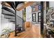 Living room with hardwood floors, spiral staircase, exposed brick, modern furniture, and a geometric rug at 1555 California St # 419, Denver, CO 80202