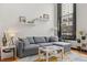 Comfortable gray sofa situated in a naturally lit living room, featuring modern decor and a geometric rug at 1555 California St # 419, Denver, CO 80202