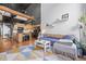 Open floor plan with modern kitchen, living room with modern furniture, and spiral staircase at 1555 California St # 419, Denver, CO 80202