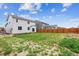 Expansive backyard with new homes surrounded by wooden fence at 1368 Orchard St, Brighton, CO 80601