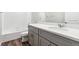 Clean bathroom with tub and shower combination and gray cabinets at 1368 Orchard St, Brighton, CO 80601