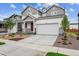 Attractive home with a concrete driveway, two-car garage, and manicured front yard at 1368 Orchard St, Brighton, CO 80601