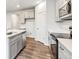 Bright kitchen features stainless steel appliances, an island, and ample gray cabinets at 1368 Orchard St, Brighton, CO 80601