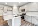 Modern kitchen features stainless steel appliances, an island, and ample gray cabinets at 1368 Orchard St, Brighton, CO 80601