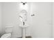 Powder room with modern sink, fixtures, and tile flooring at 2672 W 68Th Ave, Denver, CO 80221