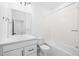 Clean bathroom with white tiled shower, bath, toilet, vanity and mirror at 2672 W 68Th Ave, Denver, CO 80221