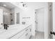 Modern bathroom featuring dual sinks, large mirror and tiled walls at 2672 W 68Th Ave, Denver, CO 80221