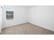 Empty bedroom with carpeting, large window with views, and white walls at 2672 W 68Th Ave, Denver, CO 80221