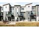 Modern townhome exterior featuring gray siding and private balconies at 2672 W 68Th Ave, Denver, CO 80221