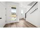 Bright foyer with a glass-panel front door, wood-look flooring, and a staircase at 2672 W 68Th Ave, Denver, CO 80221