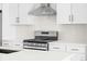 Close-up of modern stainless steel gas range and white cabinets at 2672 W 68Th Ave, Denver, CO 80221