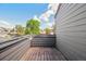 Outdoor balcony featuring wood flooring and gray railings with views of surrounding neighborhood at 11 W Ellsworth Ave # 22, Denver, CO 80223