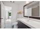 Modern bathroom features a sleek vanity, a large mirror and tiled shower at 11 W Ellsworth Ave # 22, Denver, CO 80223