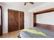 Light-filled bedroom featuring a murphy bed, hardwood floors, and a double-door closet at 11 W Ellsworth Ave # 22, Denver, CO 80223