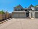 Two-car garage and driveway with neutral-colored exterior and blue sky at 11 W Ellsworth Ave # 22, Denver, CO 80223