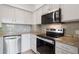 Updated kitchen features stainless steel appliances, granite countertops, and gray subway tile backsplash at 11 W Ellsworth Ave # 22, Denver, CO 80223