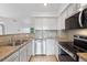 Bright kitchen features stainless steel appliances, granite countertops and gray subway tile backsplash at 11 W Ellsworth Ave # 22, Denver, CO 80223