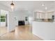 Open-concept living space with fireplace, and modern kitchen featuring stone countertops at 11 W Ellsworth Ave # 22, Denver, CO 80223