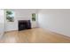 Bright living room with a fireplace and hardwood floors, illuminated by natural light from windows at 11 W Ellsworth Ave # 22, Denver, CO 80223