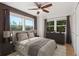 Relaxing primary bedroom with large window, ceiling fan and wooden accent wall at 11 W Ellsworth Ave # 22, Denver, CO 80223