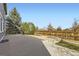 Backyard featuring a concrete patio, wooden fence, and mature landscaping with a rock garden at 6493 W 98Th Ct, Westminster, CO 80021