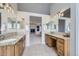 Bathroom with double sinks, granite countertops, and access to an adjacent living room at 6493 W 98Th Ct, Westminster, CO 80021