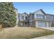 Charming two-story home with blue siding, brick accents, an attached two car garage, and a well-manicured front yard at 6493 W 98Th Ct, Westminster, CO 80021